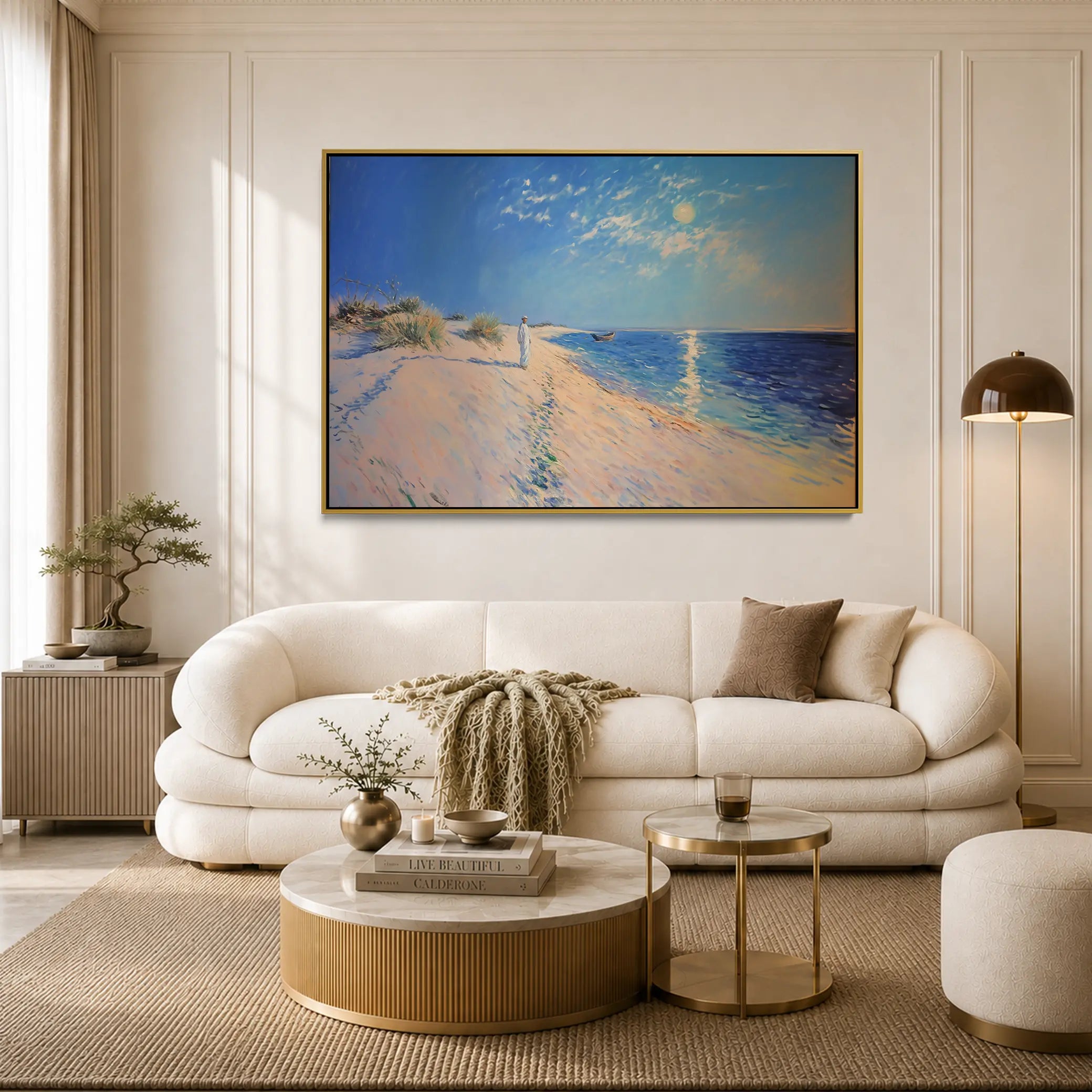 Modern living room with a white sofa, round coffee table, and beach-themed artwork on the wall.